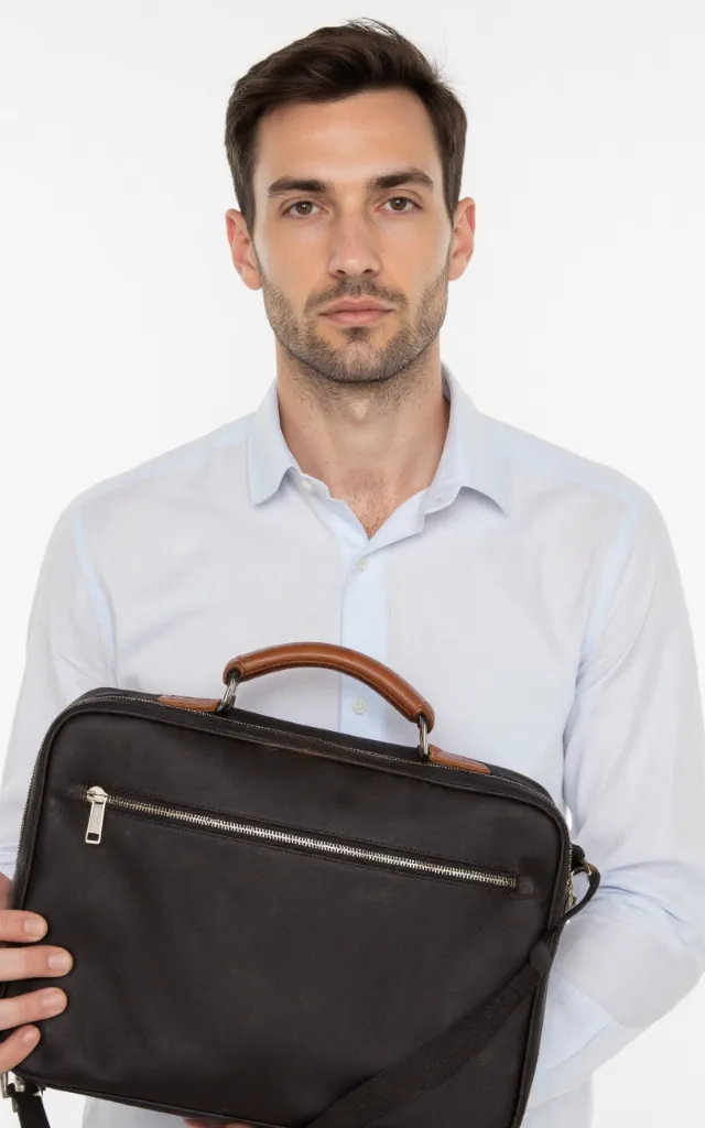 A French male model with a Zip   up briefcase, wearing a shirt, against a white background, in a front   facing close   up
